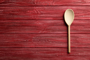 Wooden spoon on a red wooden table