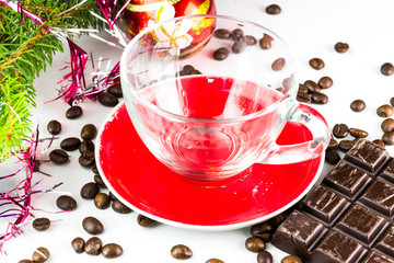 Xmas still life empty glass cup, coffee beans, chocolate, christmas tree and balls