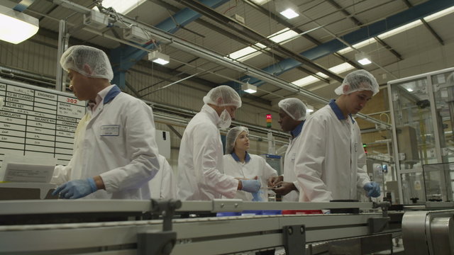  Workers on a production line in pharmaceutical and cosmetics factory