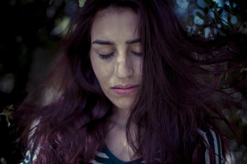 melancholic girl in a forest in autumn, red long hair