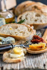 Rural lunch with bread, cheese and sun-dried tomatoes.
