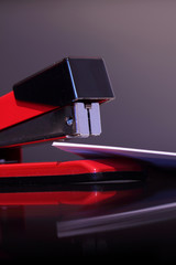 Stapler document / Stapler and document reflected on dark background
