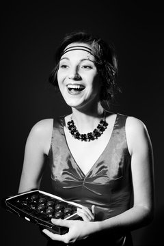 Portrait of beautiful getsby style girl eating chocolate. Black and white photography