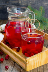Red cranberry fruit drink, a pitcher and a glass.