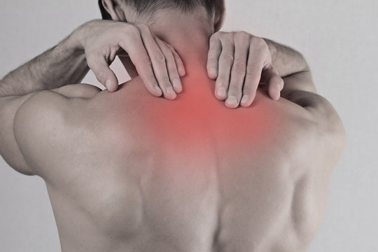 Close up of man rubbing his painful back. Pain relief concept