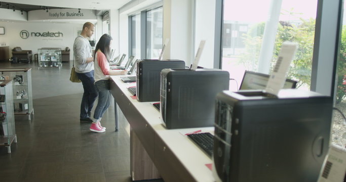 Couple Shopping In Consumer Electronics Store Showroom