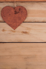 Metal heart on the wooden table