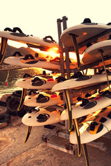 prepared windsurfing boards at sunrise. Toned.