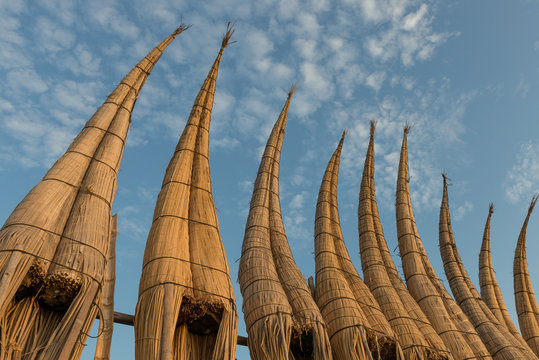 Row of boats against blue sky. This type of boats are used by local fishermen in Huanchaco, Peru