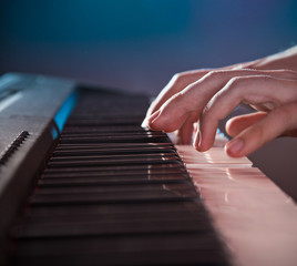 Man's hand playing piano.