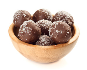 balls of chocolate covered coconut in wooden bowl