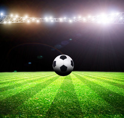 Fototapeta na wymiar Bright lights at night and soccer stadium