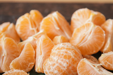 ripe peeled.mandarin.on a black background stone