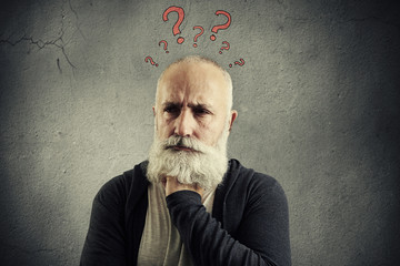 senior man with red question marks above the head