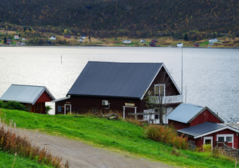 Fototapeta na wymiar Horizontal vivid Norway house on the bank of the river landscape