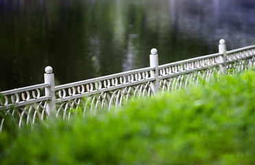 Horizontal diagonal fence in park bokeh background backdrop
