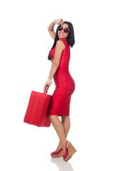 Woman in red dress with suitcase on white
