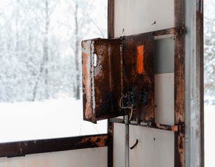 Horizontal rusty cyberpunk public call-box winter bokeh backgrou