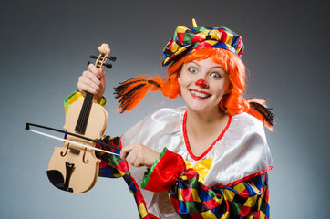 Clown in funny concept on dark background