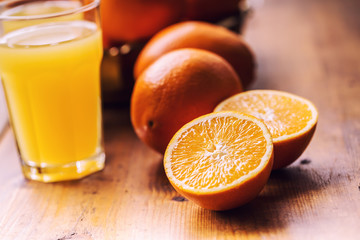 Obraz na płótnie Canvas Fresh oranges. Cut oranges. Pressed orange manual method. Oranges and sliced oranges with juice and squeezer.