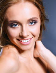 Obraz premium Beautiful woman with curly long hair on dark background