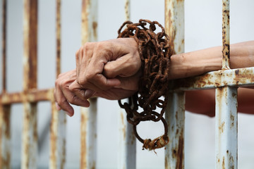 hand in jail with rusty chain