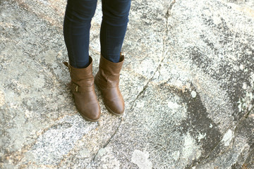 Boots of a Woman walking on a Rock