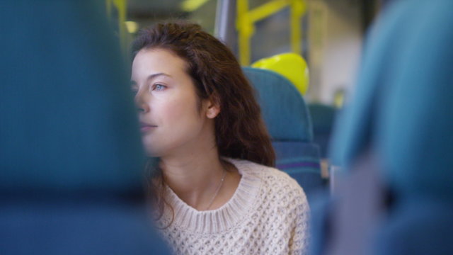  young female using her digital tablet on a moving train