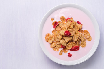 Top view of a plate of muesli with yogurt and space for text