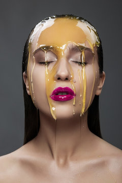 Woman With A Honey On Her Face And Pink Lips