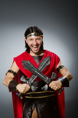 Fototapeta na wymiar Roman warrior with sword against background