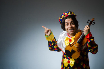 Funny violin clown player in musical concept