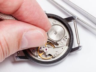 watchmaker repairs old watch close up