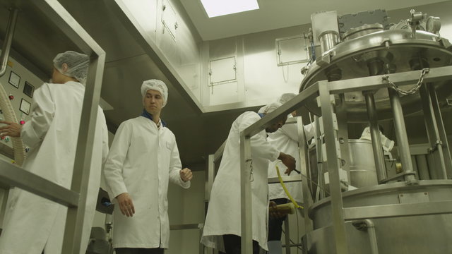  Scientists in  research factory. Technicians operate production machinery. Technology manufacturing facilities. Power station components that emulate nuclear facilities.