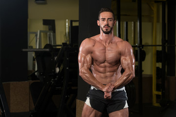 Fototapeta na wymiar Handsome Body Builder Making Most Muscular Pose