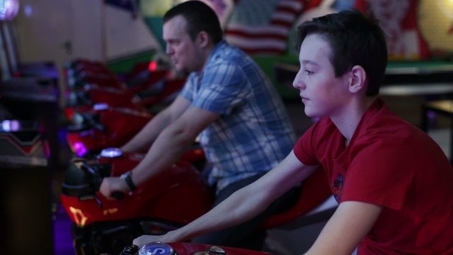 Man and teen ride on motorbike simulation game
