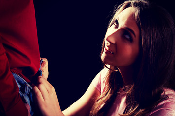 Woman undressing her man.