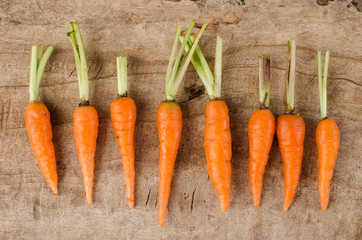 Fresh carrots arrange on wooden background