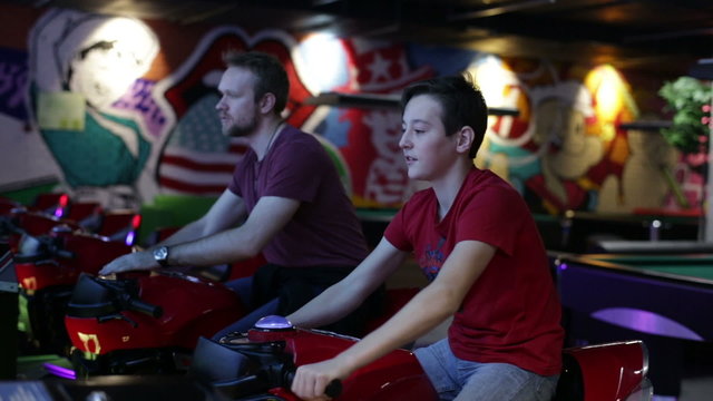 Teen and man ride on motorbike simulation game