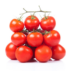 fresh tomatoes with green leaves isolated on white background