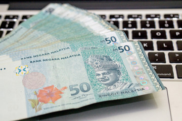 Ringgit Malaysia on keyboard notebook. Malaysia currency having a currency crisis in year 2015 due to market oil price