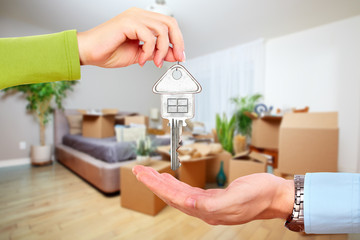 Hand with house key.