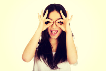 Young woman doing the perfect sign on eye.