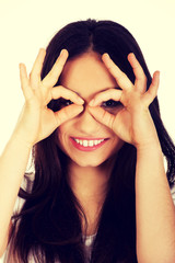 Young woman doing the perfect sign on eye.