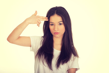Fototapeta premium Young woman showing suicide sign.