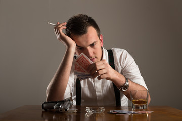portrait of young man smoking and play poker