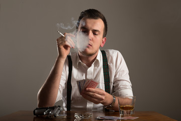 portrait of young man smoking and play poker