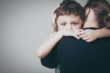 sad son hugging his mother