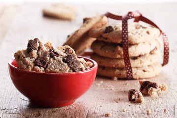 chocolate cookies in red cup on wooden table