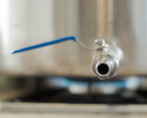 Stainless faucet kettle on the gas stove